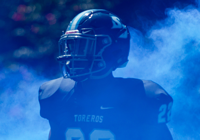 Daniel Tolbert runs through blue smoke