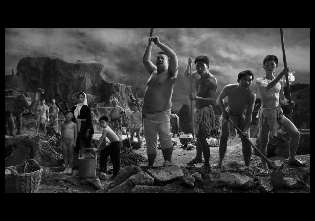 This is a movie still showing people mining on a mountain. Yang Fudong, Moving Mountains, 2016, film still. Single channel film, black and white, 5.1 sound track, music by Jin Wang; 46 min. 30 sec. Co