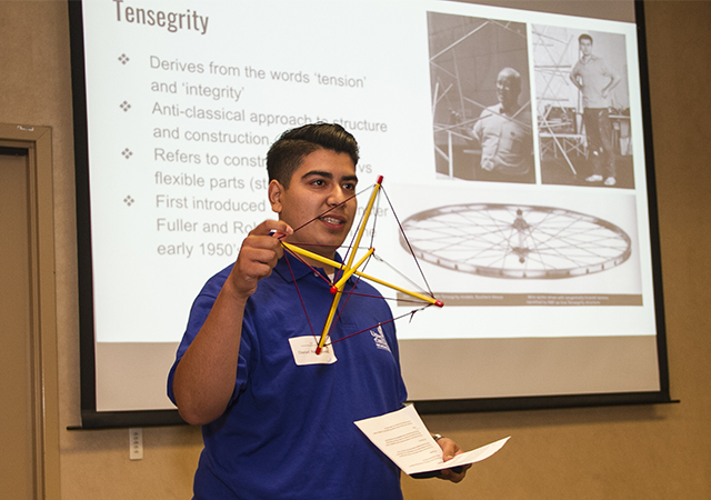 A USD student presents his research at the Summer Colloquium