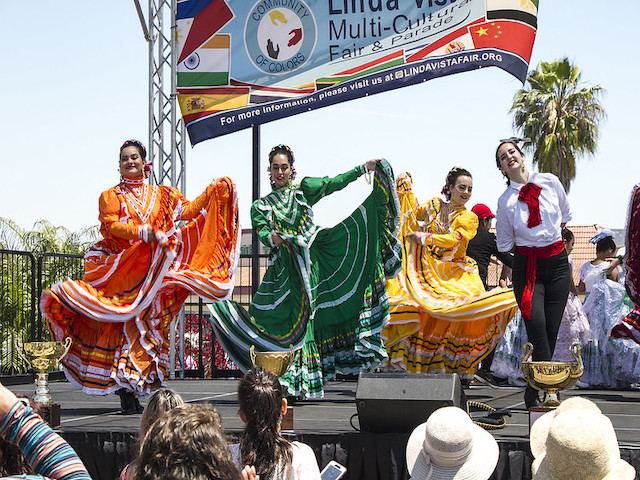Women dancing in colorful outfits