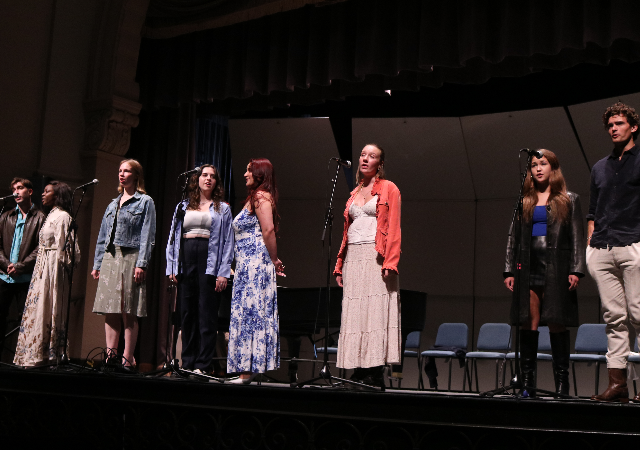 Students singing in the song story stage performance Spring 2023