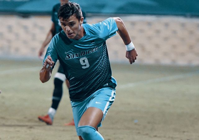 Men's soccer team player, Miguel Berry pursues a loose ball