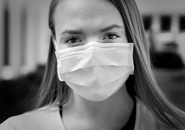 Campus nursing coordinator with mask on looking at the camera