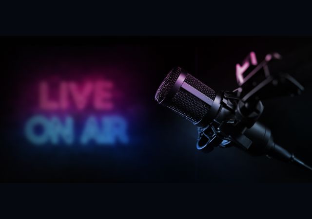 This is an image of a microphone against a black background with the text "Live on air" 