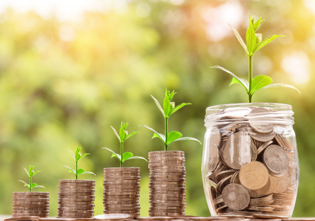 coins in jars with plants growing from them