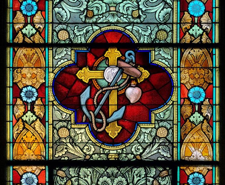 Saint Peter Roman Catholic Church, in Saint Charles, Missouri, USA - stained glass window of cross and anchor 