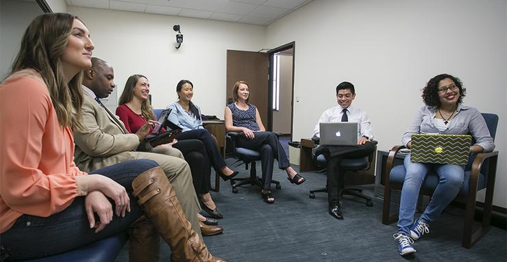 SOLES graduate students having a discussion in a classroom setting