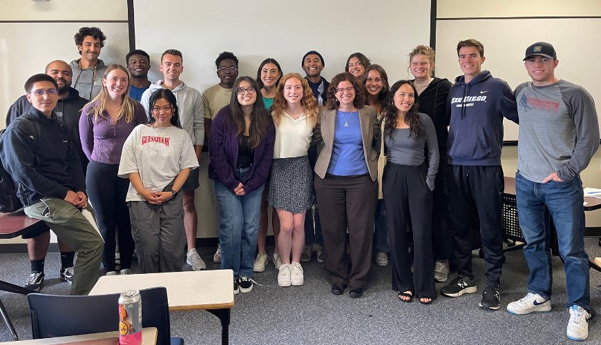 Dr. Susan Lord poses in the middle of a group of students who were a part of her solar energy course.