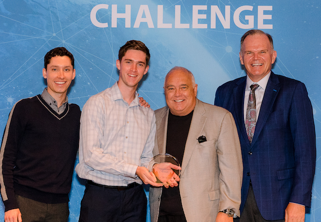 Ron Fowler and USD President James T. Harris III stand with student winners at the 2019 Fowler Global Social Innovation Challenge.