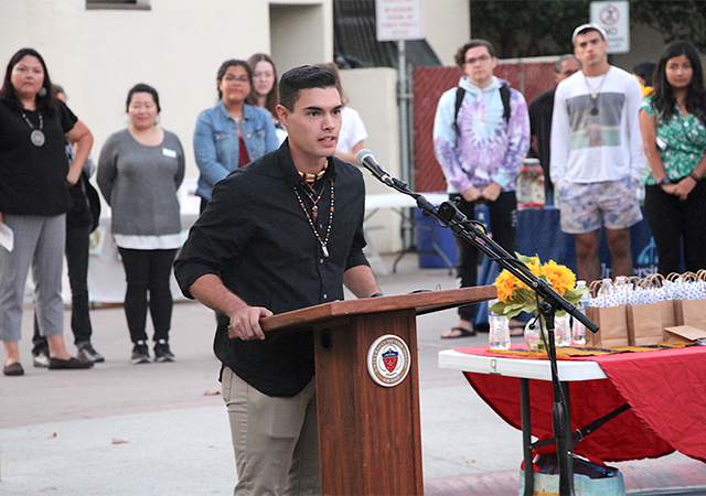 Gabriel Fallis, USD students and AISO Chairman, speaks to the audience during Monday's Mata'yuum Crossroads renaming celebration.