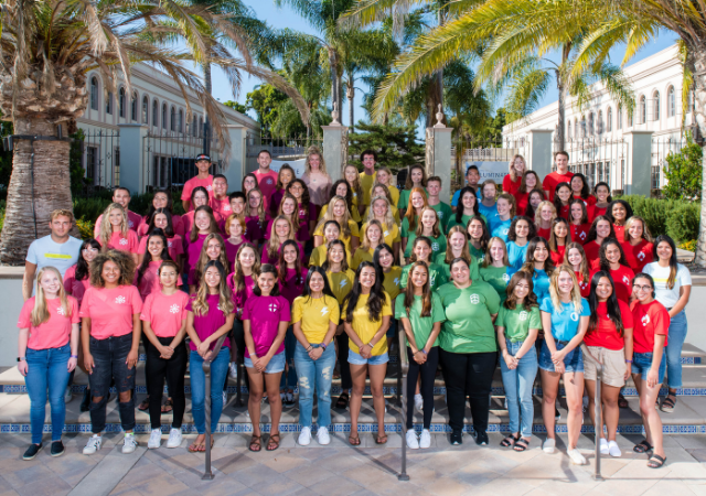 student leaders standing on stairs on campus