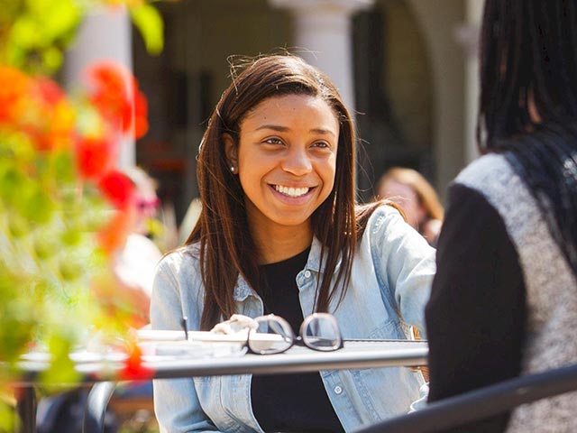 A student talking with a friend on campus